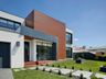 Two-story home with a lawn and a stepping-stone path